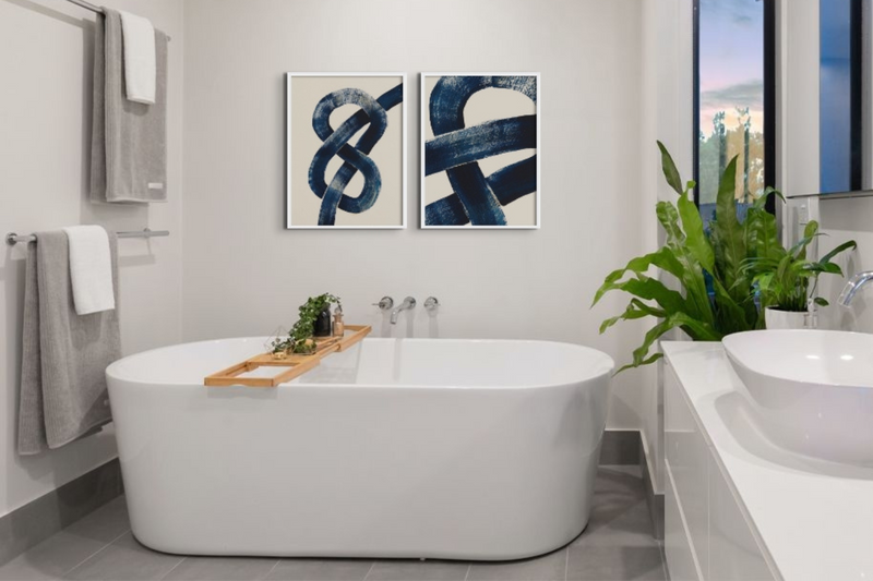 Navy abstract bathroom art prints above freestanding bathroom - framed coastal bathroom wall art