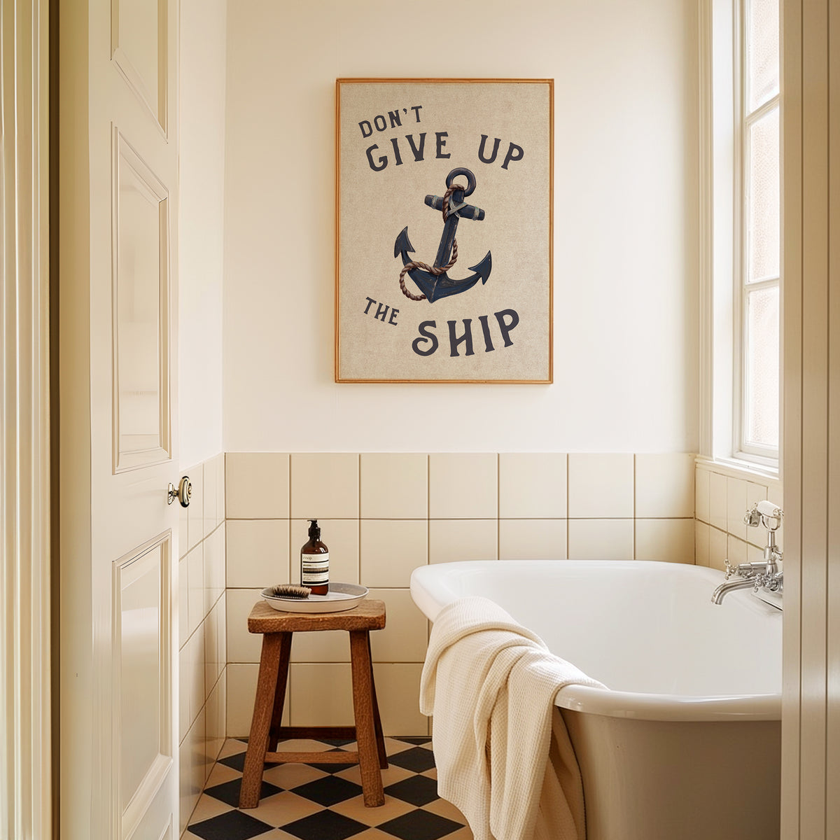 Bathroom with a bathtub, stool, and framed quote on the wall.