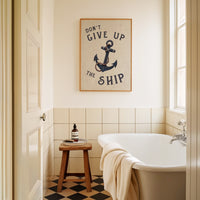 Bathroom with a bathtub, stool, and framed quote on the wall.