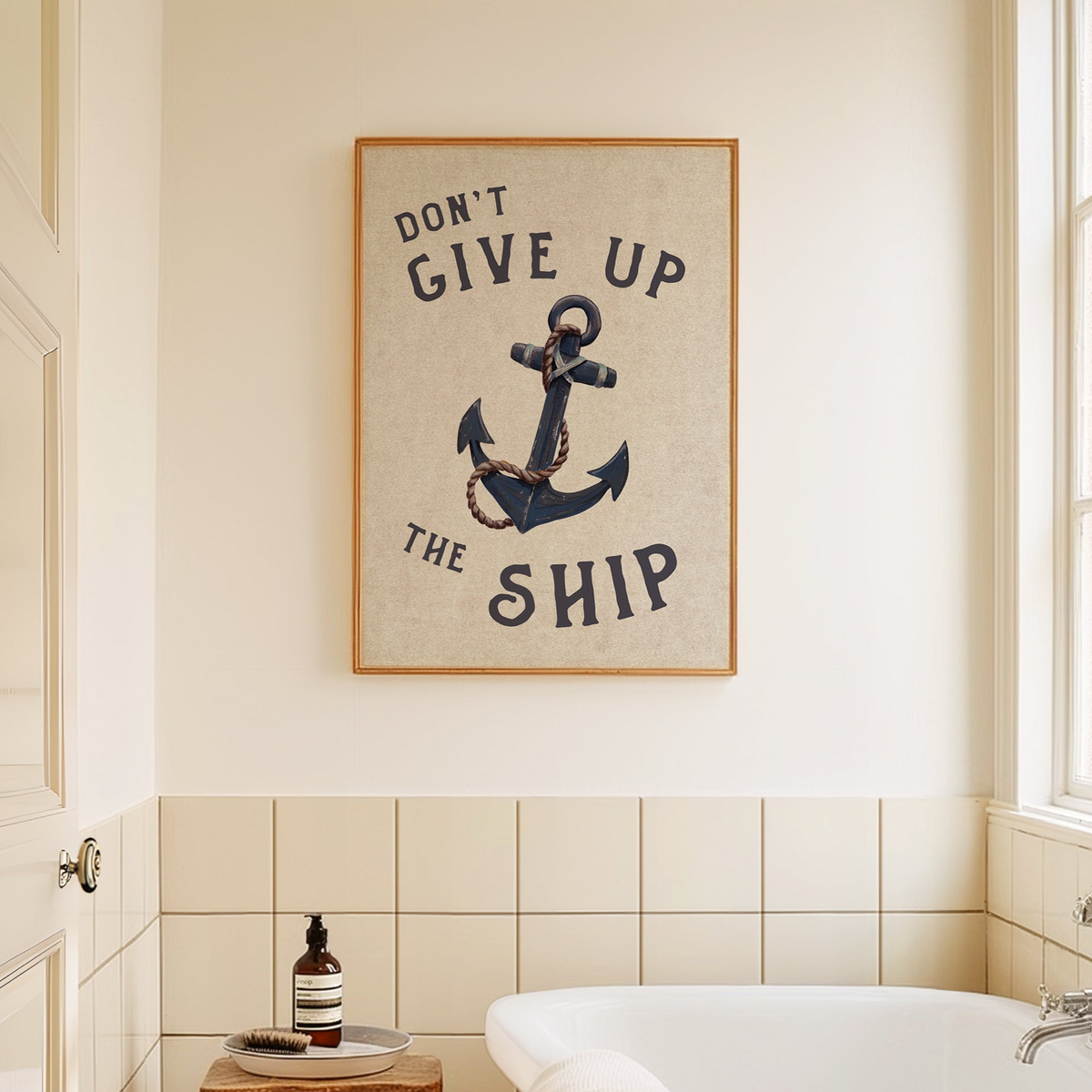 Bathroom with framed artwork featuring an anchor and text on the wall.