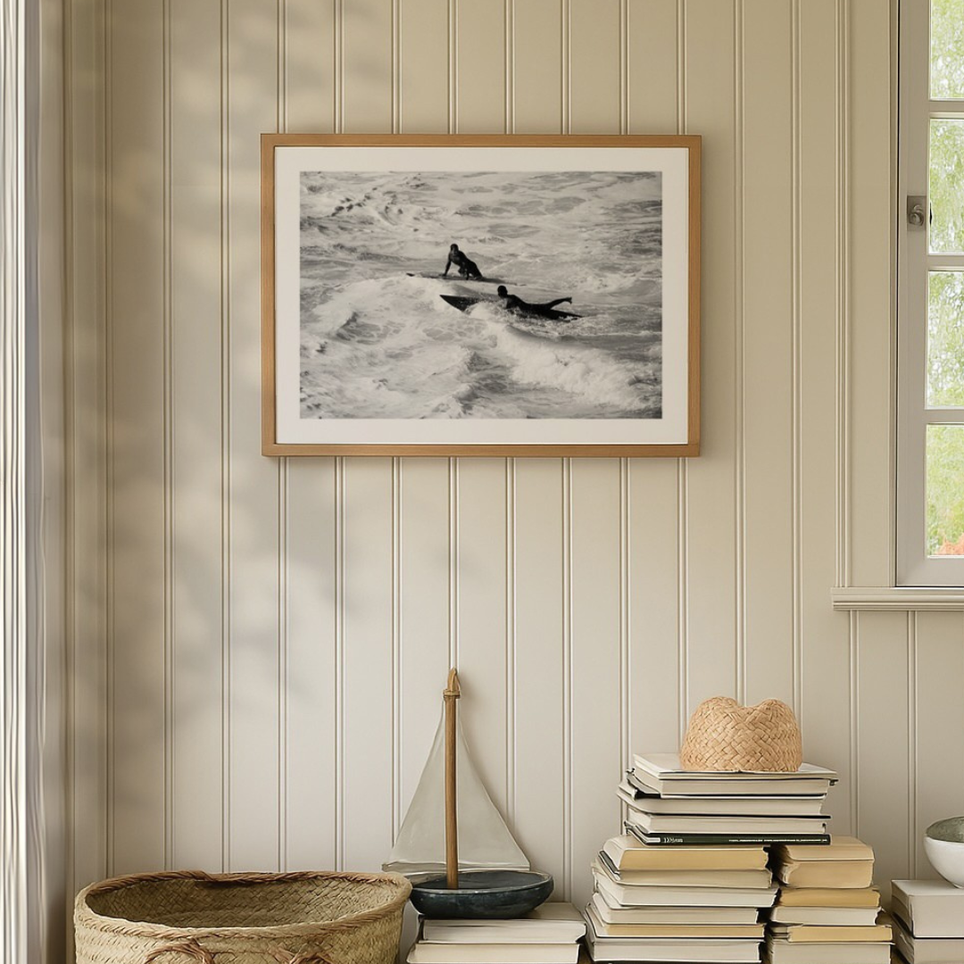 framed surfing photograph - framed coastal art print on shiplap wall