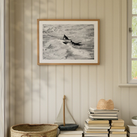 framed surfing photograph - framed coastal art print on shiplap wall