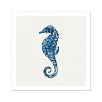 A framed print of an indigo blue colored seahorse on a white background.