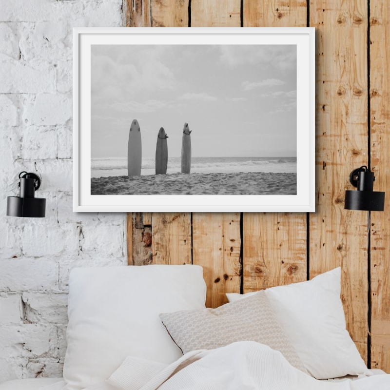 a black and white beach photography print on wall in bedroom - framed beach photography print
