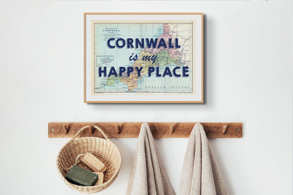 map prints above coat hooks in hallway