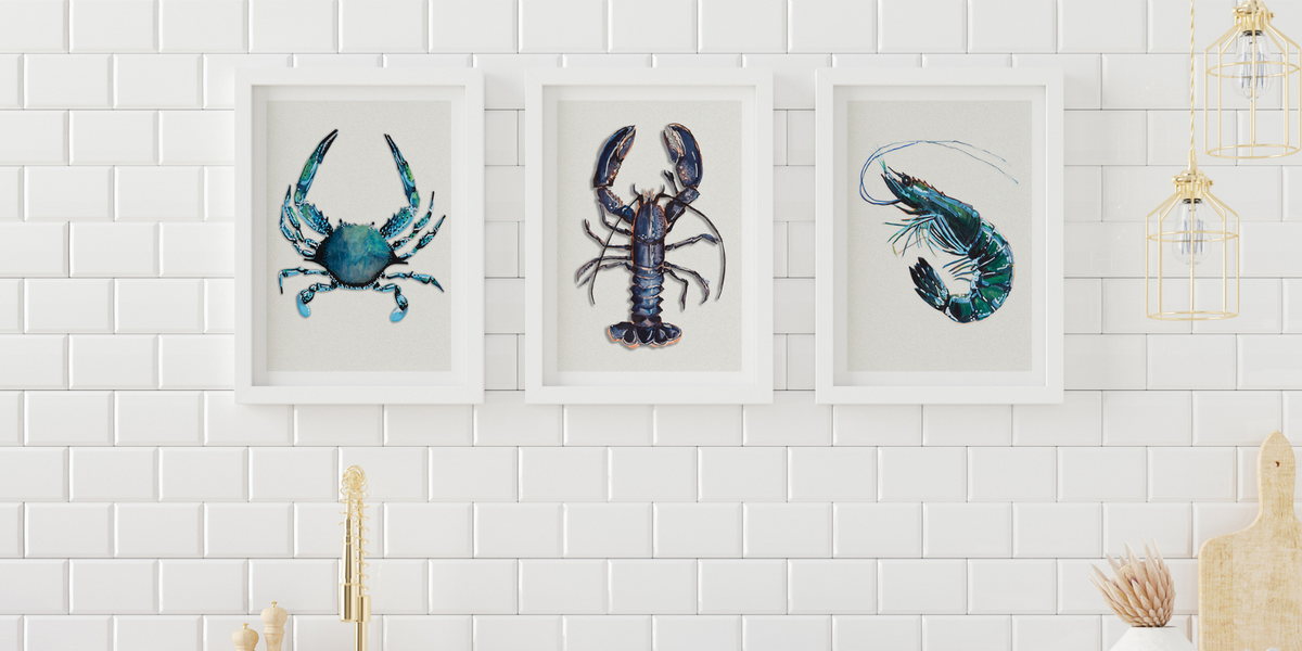 set of three kitchen wall art prints on wall above sink - shell fish kitchen prints framed on tiled wall