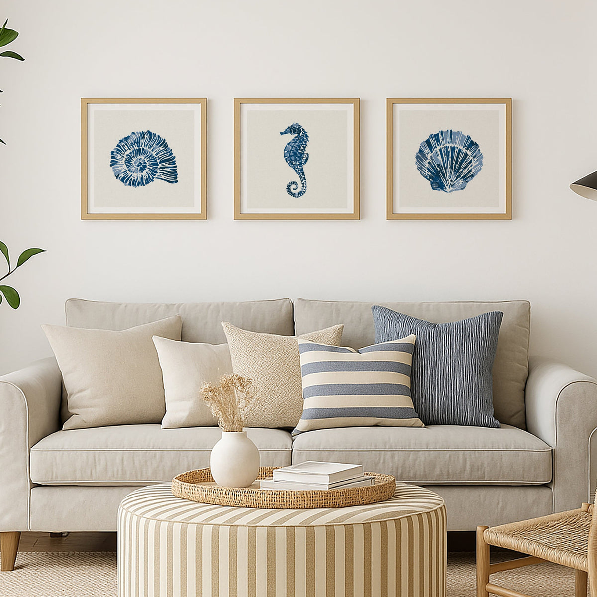 set of three coastal art prints on wall in living room - set of shell prints in blue paint