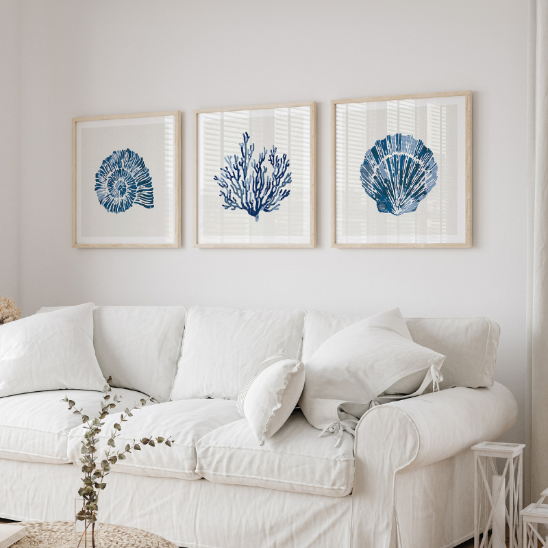 set of three coastal art prints above sofa in living room. coastal art print by beach house art