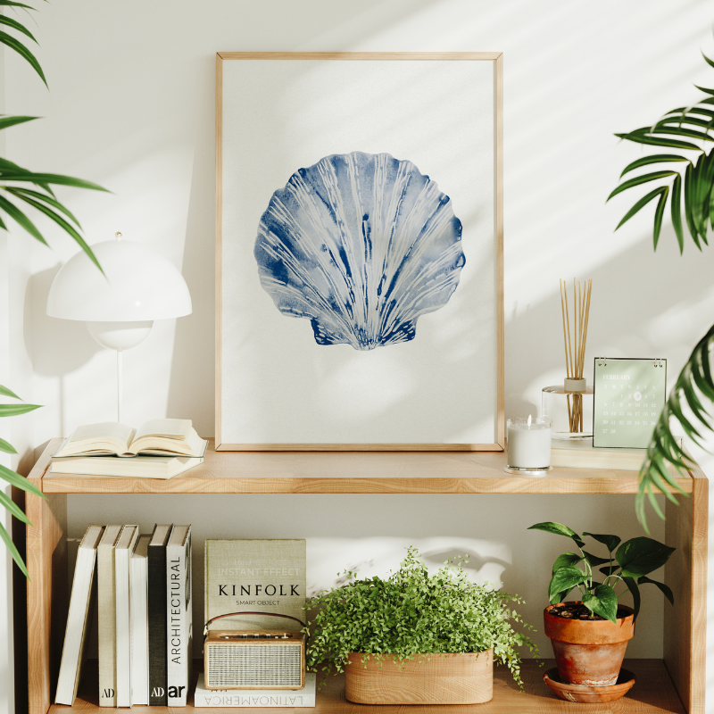 painted shell art print on book shelf in living room. seashell painting by beach house art