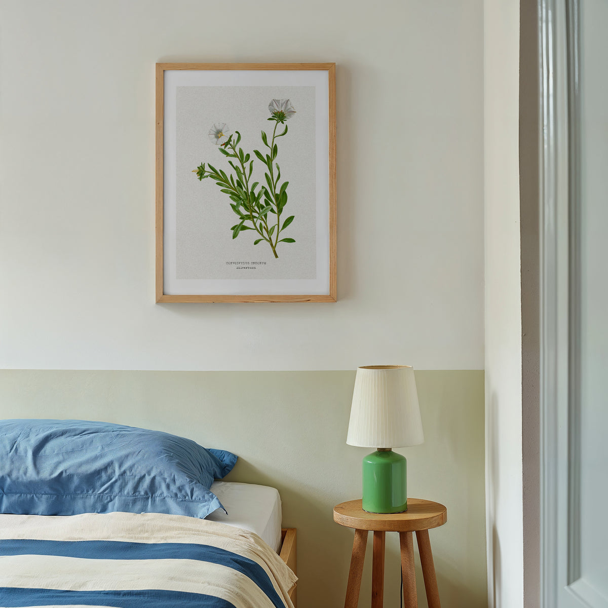 vintage flower paitning on wall in bedroom - vintage silverbush botanical art print framed with natural wood frame on wall above bedorom