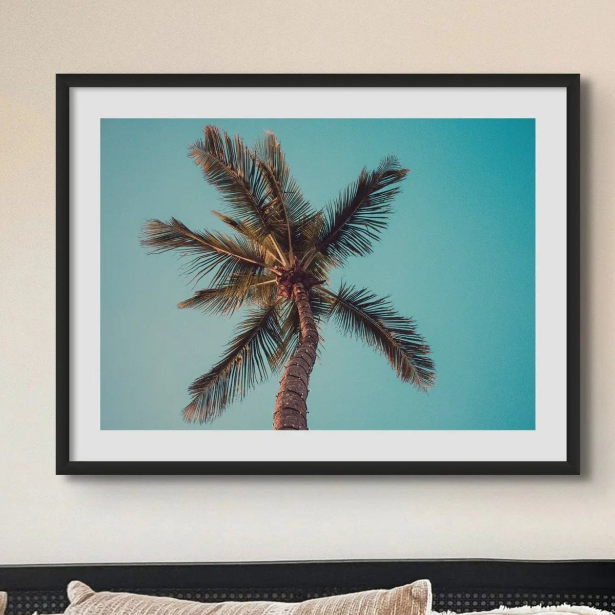 colour photograph of a palm tree against a blue green sky in a neutral bedroom- beach house art