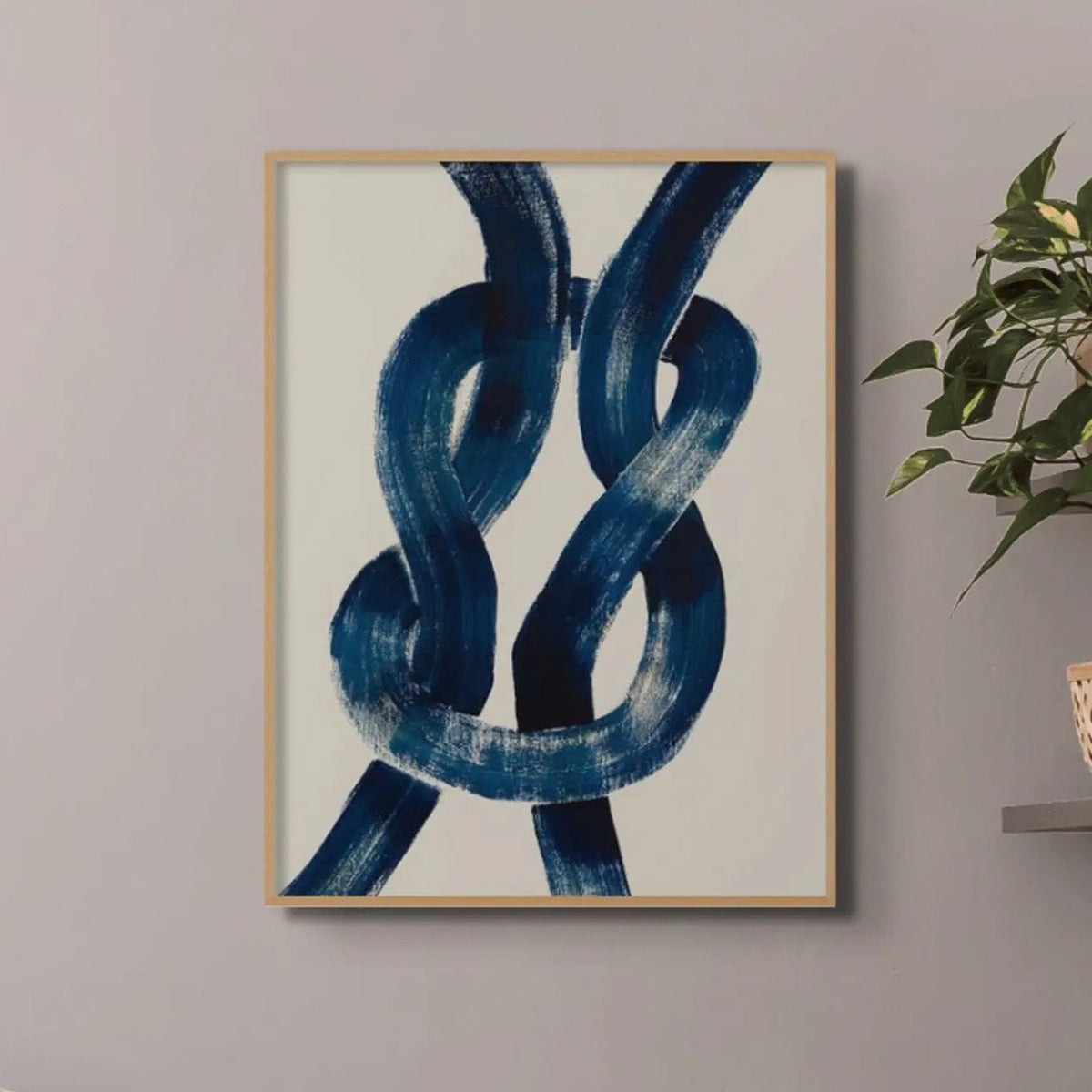 wall art print of a navy reef knot on a beige background in a small living room