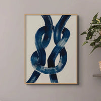 wall art print of a navy reef knot on a beige background in a small living room