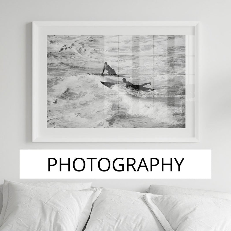 Aerial beach photo framed in black above sofa