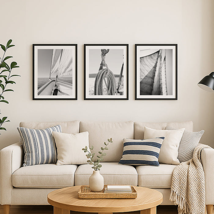Living room with beige sofa, wooden coffee table, and framed black and white pictures on the wall.