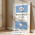 Personalised baby name print - Framed artwork with 'Olivia Grace' and a date on a blue background, leaning against a wall.