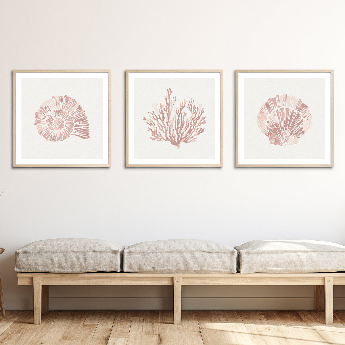 set of three scallop and shell art prints in pink colours on wall above bench