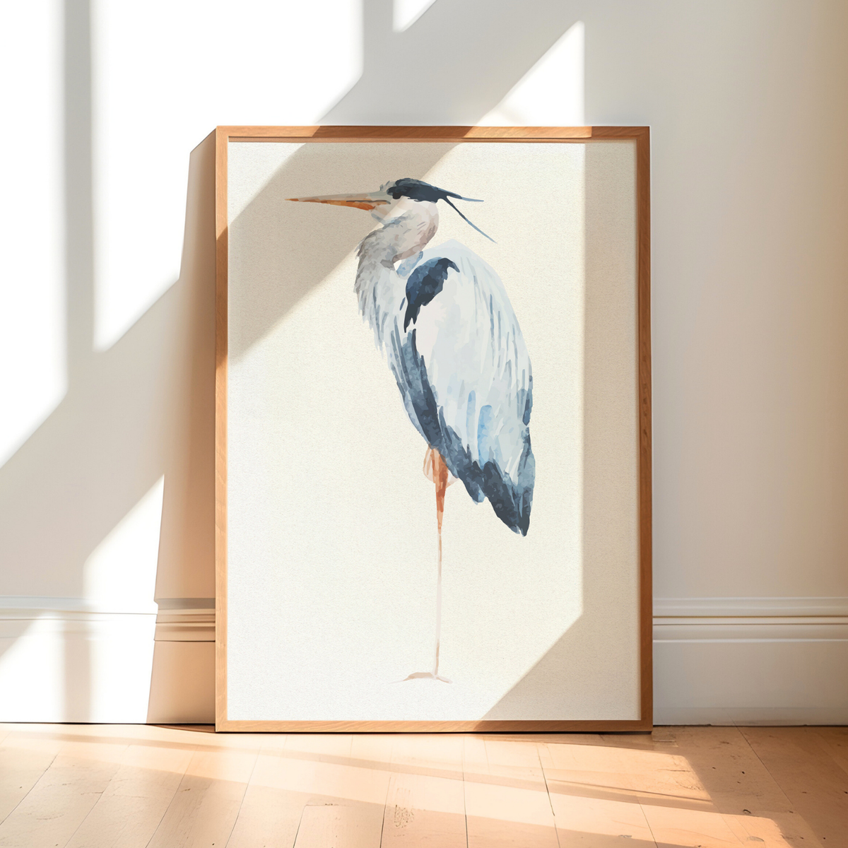 Heron art pint - Framed artwork of a heron on a white wall with sunlight casting shadows.