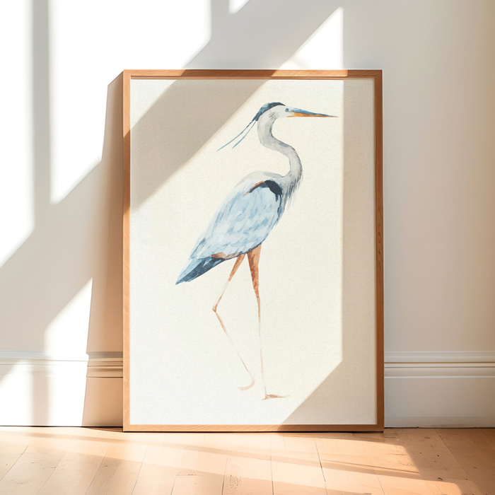 Heron print - Framed artwork of a heron on a white wall with natural light casting shadows.
