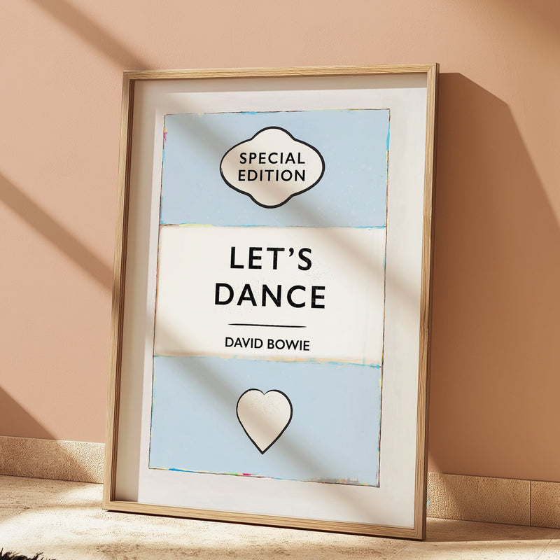 Framed poster with 'Special Edition Let's Dance David Bowie' text on a beige wall.