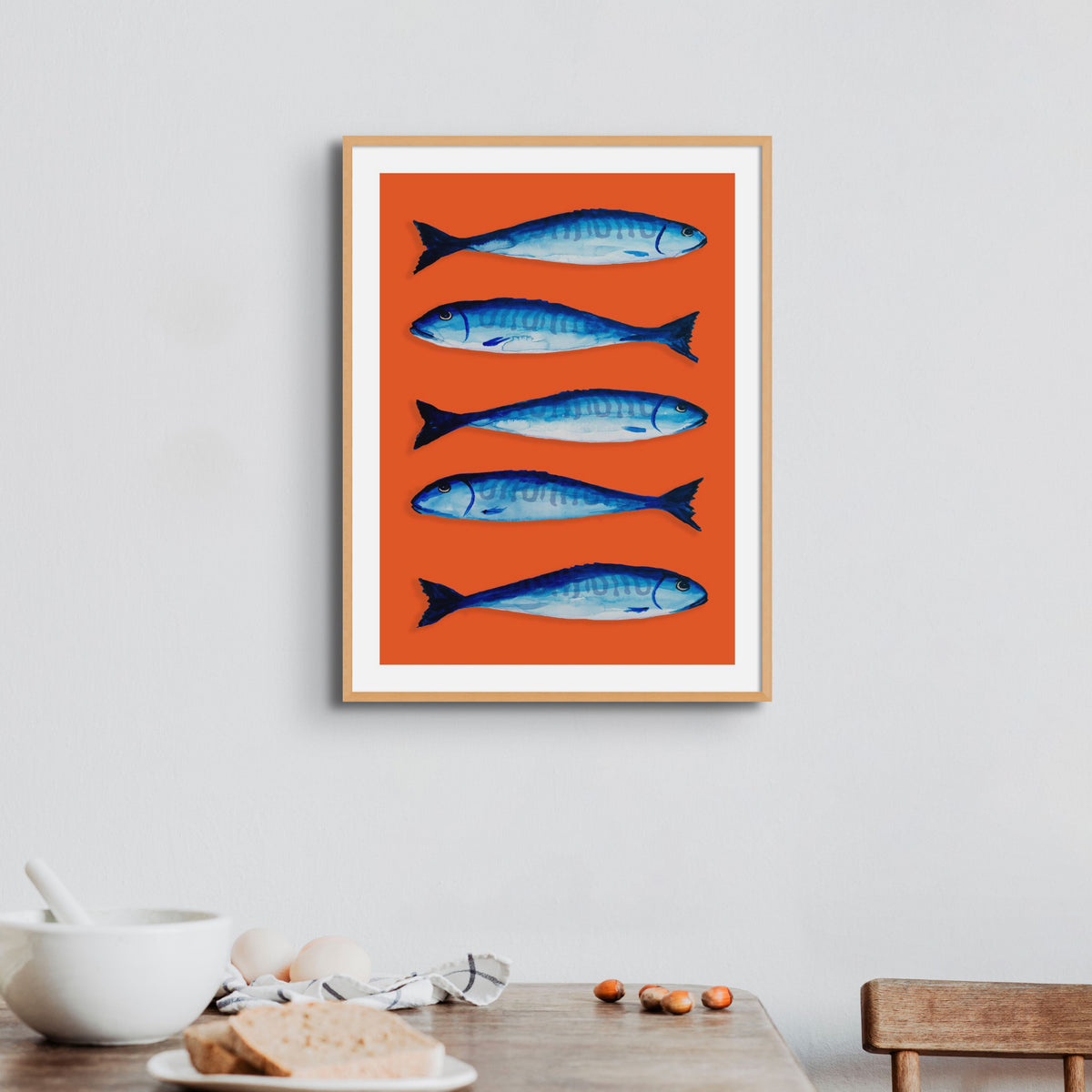 red fish part print on wall above dining table - colourful kitchen wall art