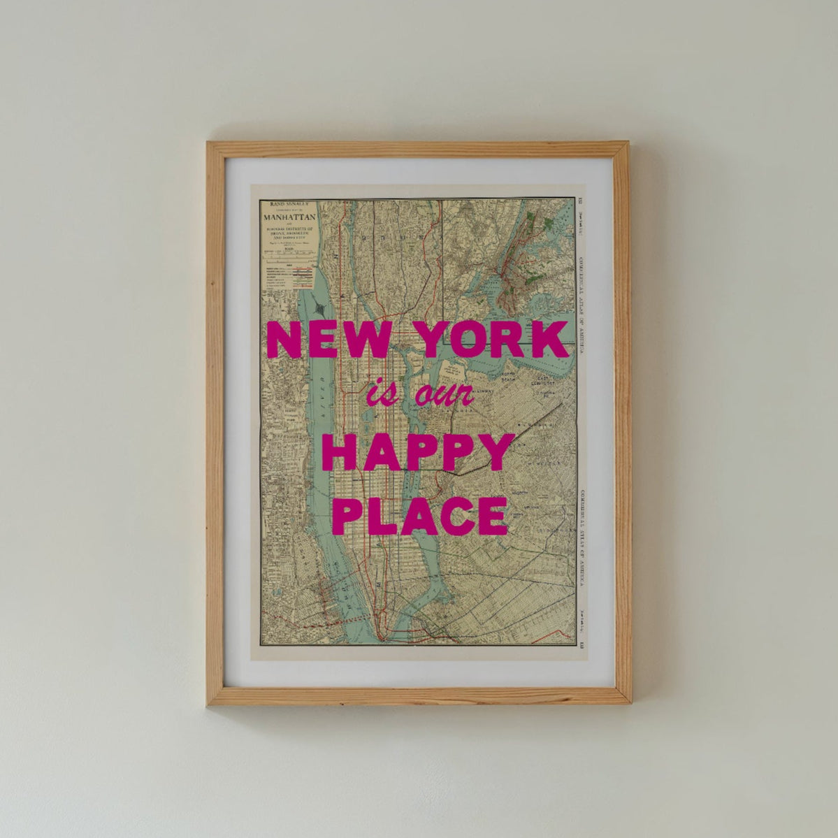 Framed map with 'New York is our happy place' text above a bed in a bedroom.