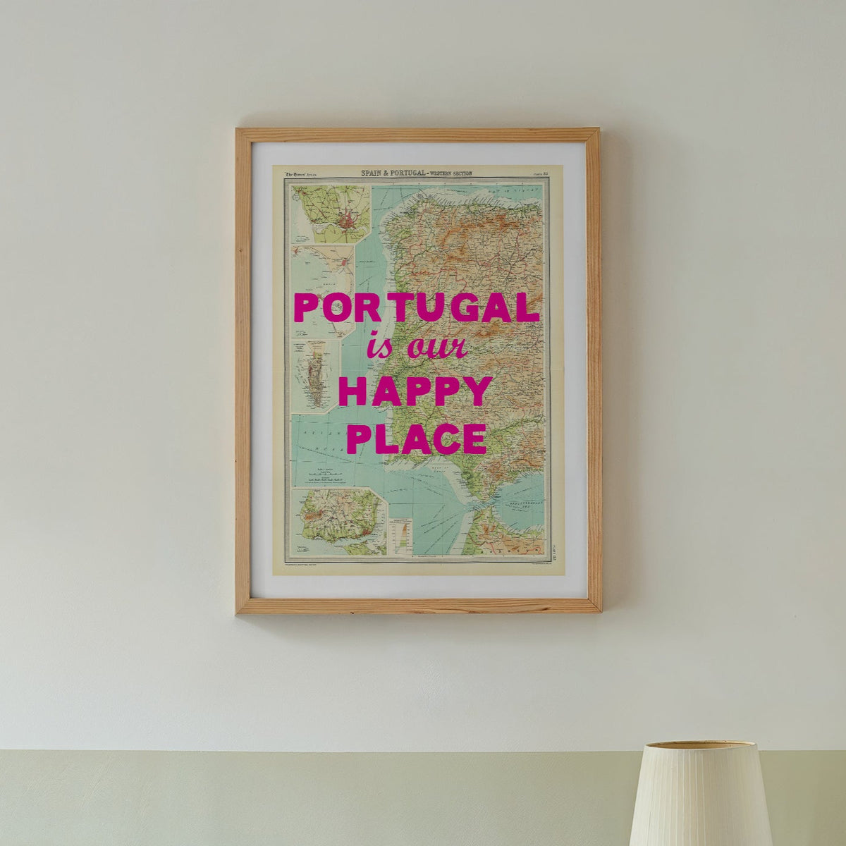 Bedroom with a map of Portugal on the wall and a green lamp on a side table.