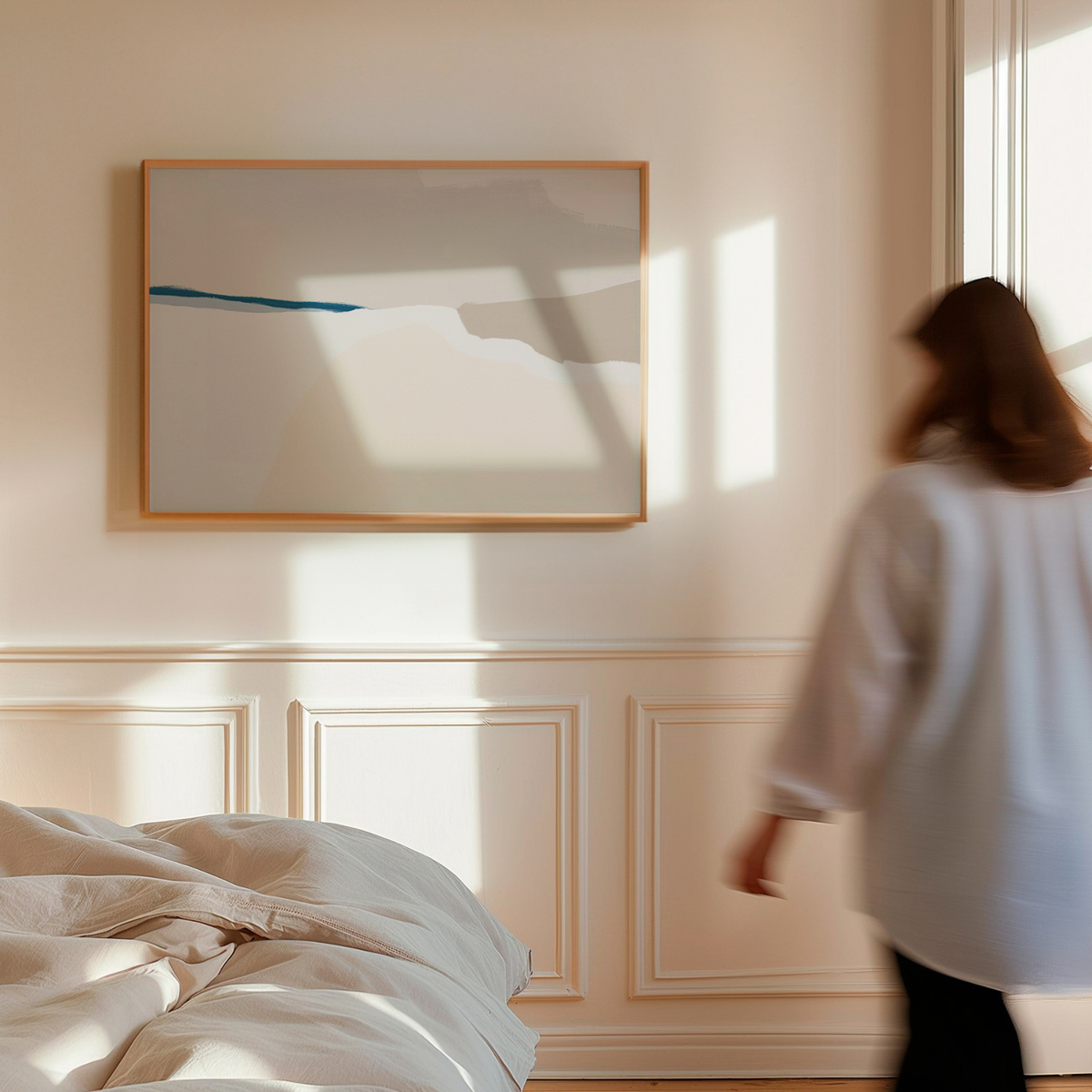 Woman walking in a bedroom with a large abstract painting on the wall