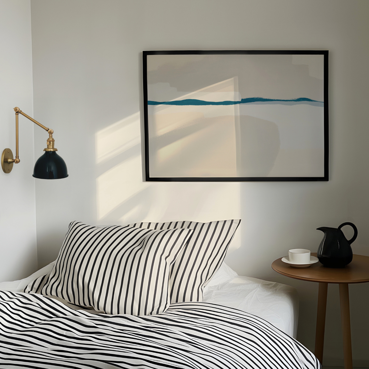 Bedroom with striped bedding, a lamp, and a framed abstract painting on the wall.