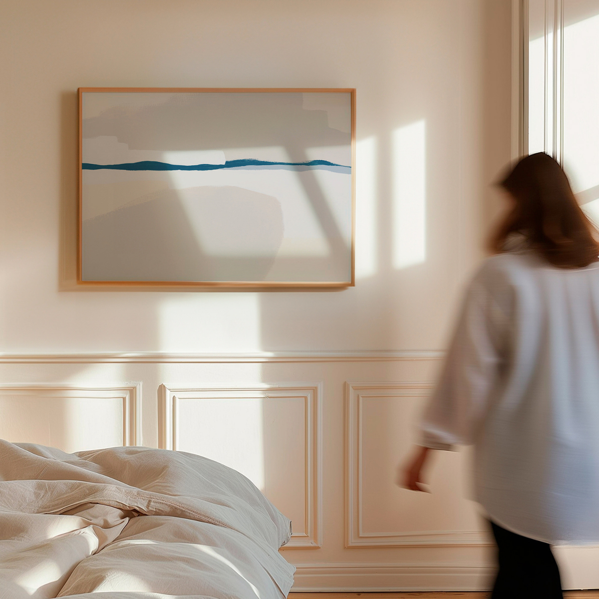 Woman walking in a bedroom with abstract art on the wall