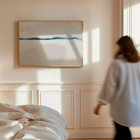 Woman walking in a bedroom with abstract art on the wall