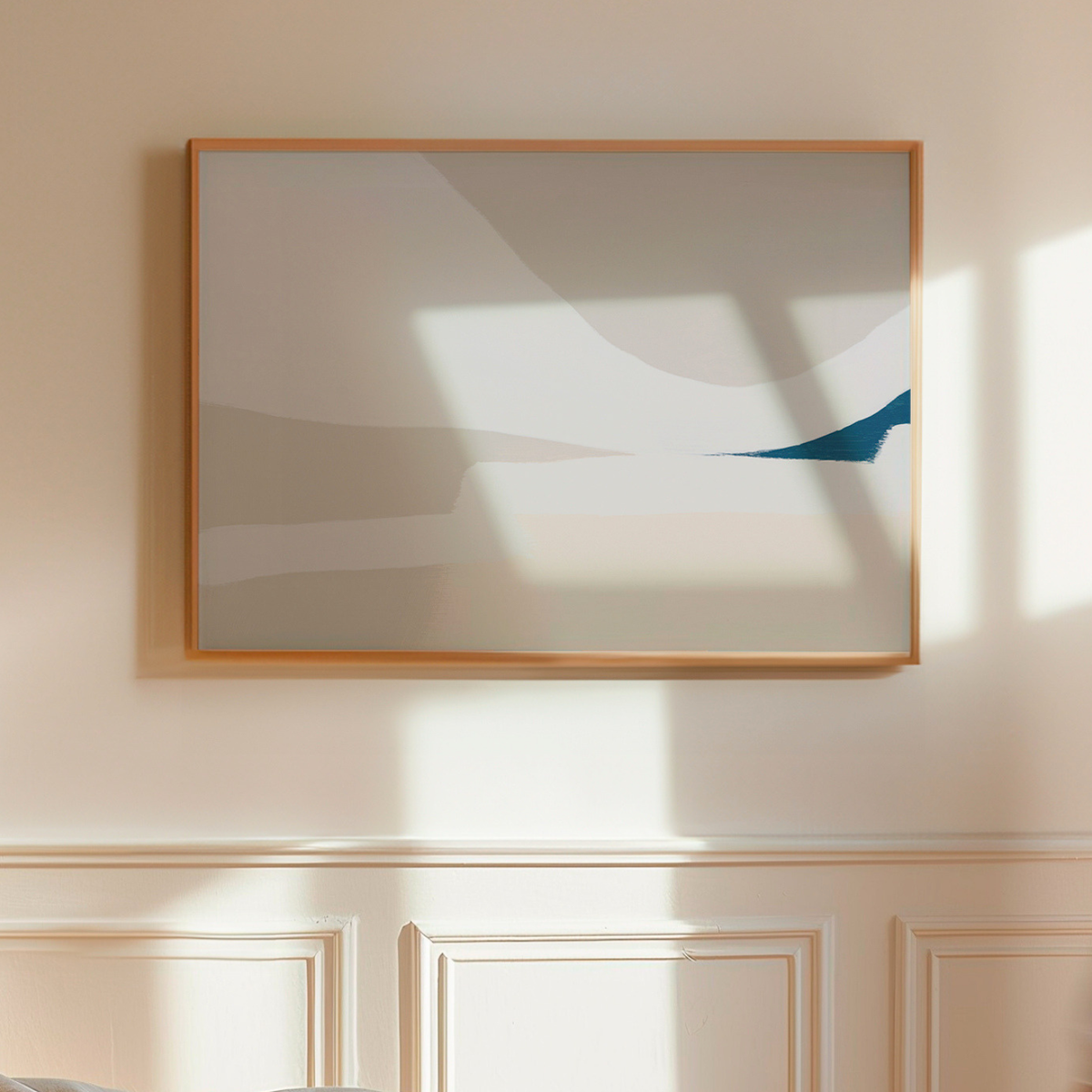Abstract beach painting with a wooden frame on a wall