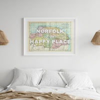 Norfolk is our happy place map print on wall above bed.