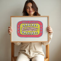 Sardine tin painting - Person holding a framed artwork of a sardine label against a plain background.