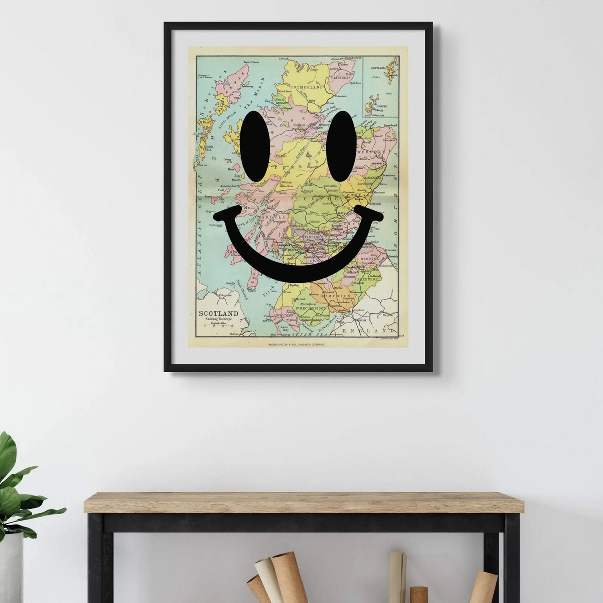 Framed vintage map art of Scotland with a smiling face added in modern typography.