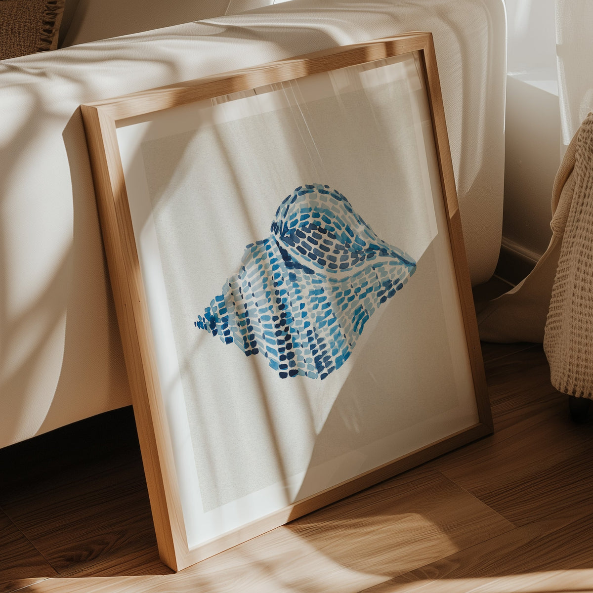 Conch shell painting with layered blue brushstrokes on a neutral background, contemporary coastal wall art in living room