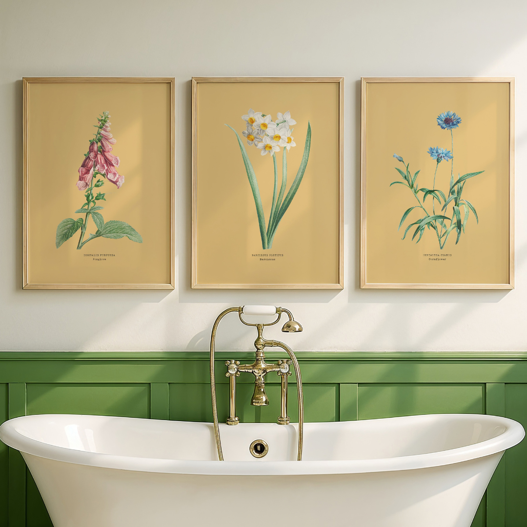 Set of three floral art prints with yellow background in bathroom.