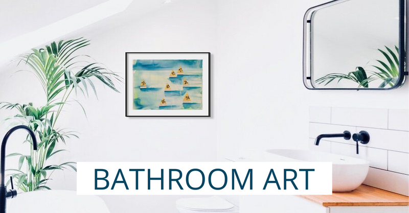 white bathroom with black taps and coastal artwork