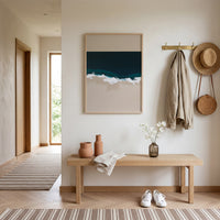 Modern hallway with wooden bench, artwork, and decor items.