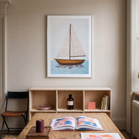 Room interior with a wooden table, bookshelf, and wall art of a sailboat.