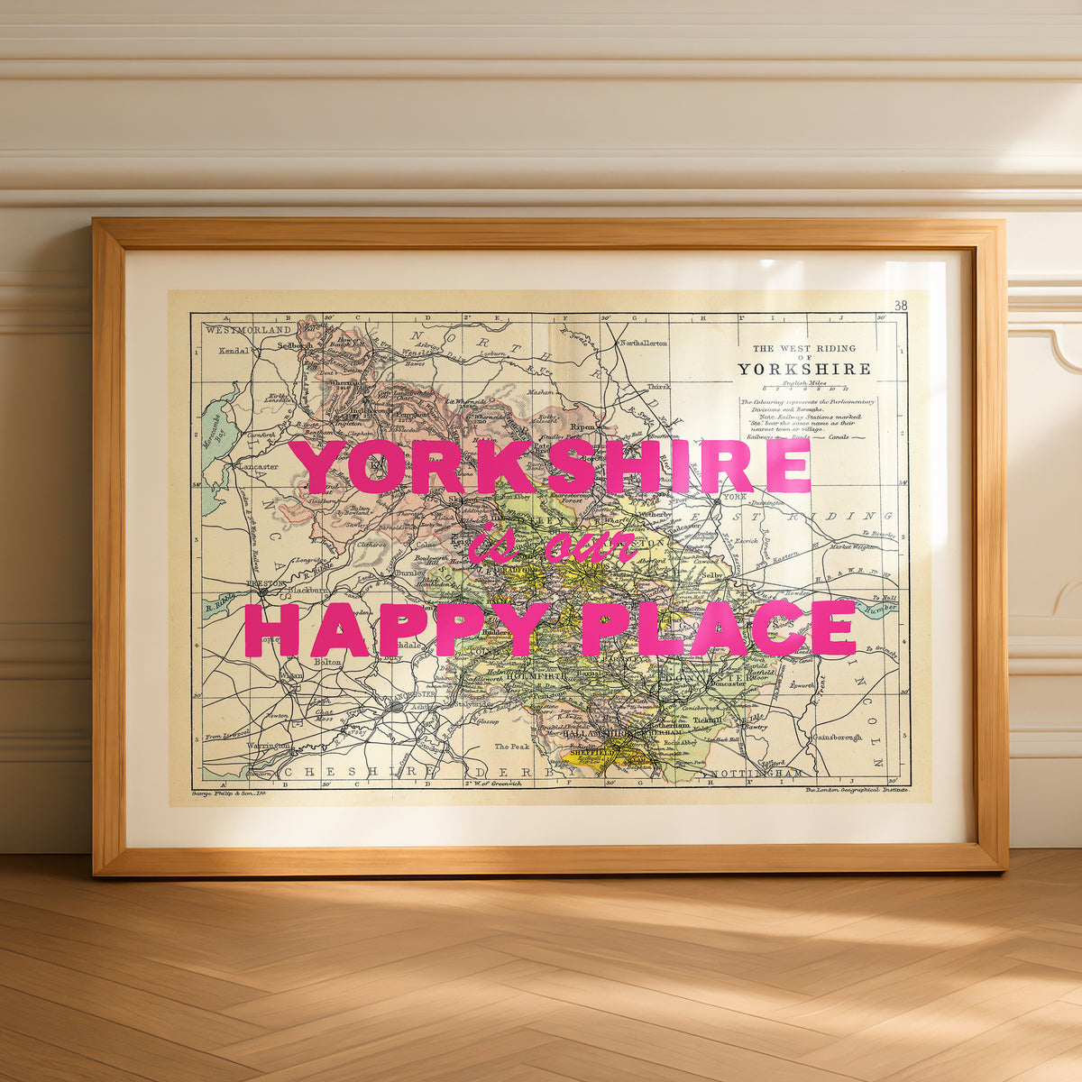 Framed map of Yorkshire with 'Yorkshire is our happy place' text on a wooden floor.