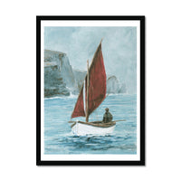 Framed artwork of a sailboat with a red sail on a body of water. Cornish Sea Painting