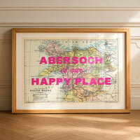 Framed map of Abersoch with 'Abersoch is our happy place' text on a wooden floor.