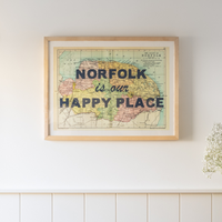 framed map print on wall with norfolk is our happy place quote in blue font.