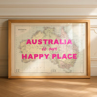 Framed map of Australia with 'Australia is our Happy Place' text on a wooden floor.