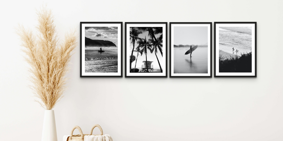 set of framed beach photography prints on wall in living room. Black and white beach photography prints by beach house art