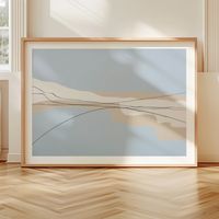 Framed abstract artwork on a wooden floor with a neutral wall background