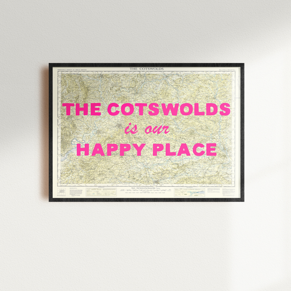Framed map with 'The Cotswolds is our happy place' text on a plain background