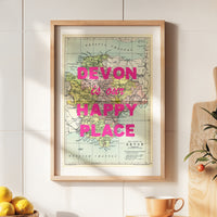 Framed map of Devon with 'Devon is our happy place' text on a wall.