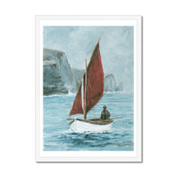 Framed artwork of a sailboat with a red sail on a body of water.
